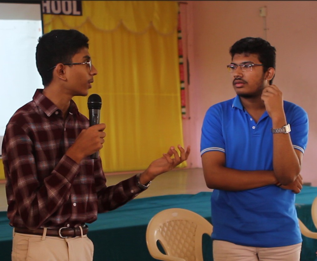Saatvik Karthikeyan giving a speech and answering questions from students at Amala Metric Higher Secondary School